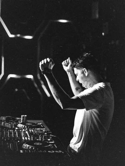 A classic black and white shot, capturing the raw emotion and energy of a rock star DJ.