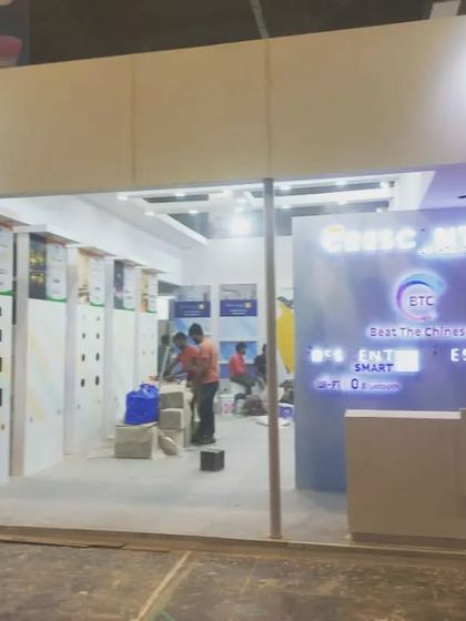 Workers put the finishing touches on the "Beat The Chinese" (BTC) booth, preparing for the show opening.