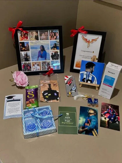 All the contents of the sports-themed graduation hamper laid out. You can see the custom photo collage, chocolates, skincare, and other thoughtful gifts chosen for the graduate.