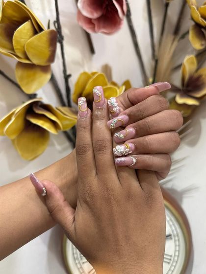 Another view of the elaborate bridal nail set, highlighting the delicate 3D floral work and the carefully placed gold and crystal embellishments.