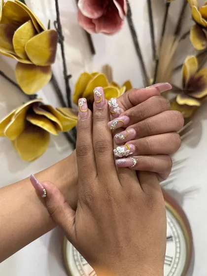 Another view of the elaborate bridal nail set, highlighting the delicate 3D floral work and the carefully placed gold and crystal embellishments.