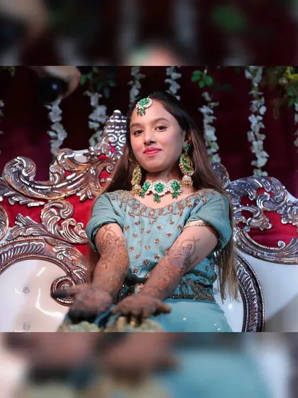 The bride showing off her full bridal mehendi. She looks absolutely radiant.