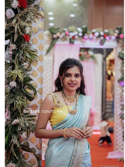 A client looking fresh and elegant in a pastel blue saree paired with a contrasting bright yellow sleeveless blouse I designed. This simple yet striking combination is perfect for daytime events and celebrations.