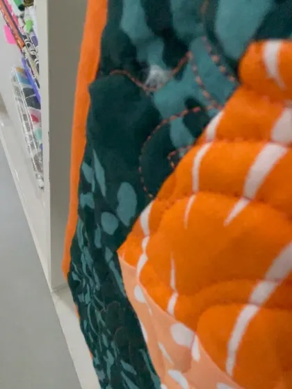 An extreme close-up showing the thickness of the batting and the texture of the quilting.