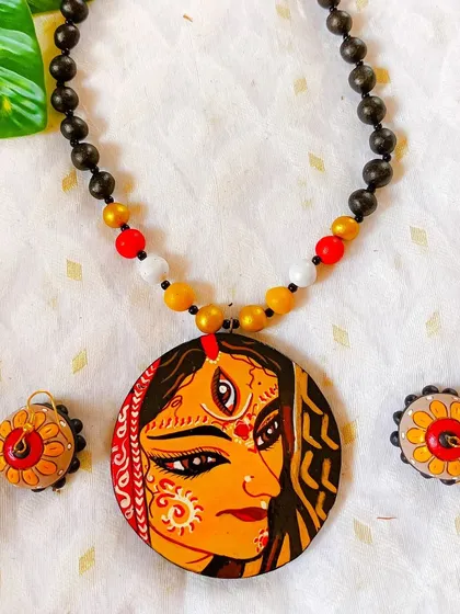 This is a more ornate, bridal-style depiction of a goddess, with intricate alpona designs on her face. The detailed line work and traditional elements make this a truly special piece.