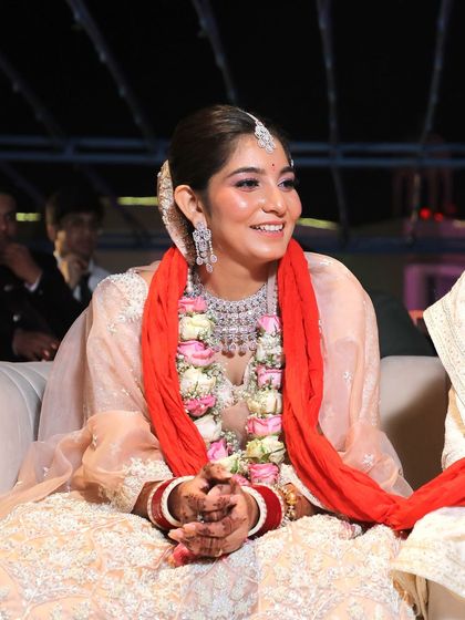 A beautiful, smiling candid of the bride during her wedding ceremony.