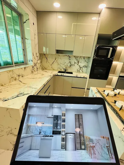 We believe in transparency from concept to reality. This image shows how our detailed 3D render, held up on the tablet, perfectly matches the finished kitchen, giving our clients complete confidence in the final outcome.