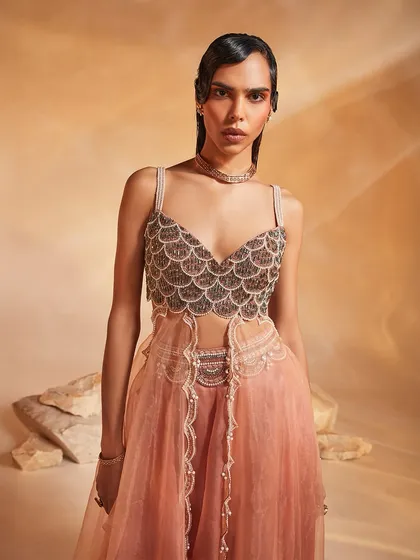 A close-up of the Arlo Co-ord Set's bodice, featuring intricate scallop embellishments and contrasting green stones for a serene yet detailed look.