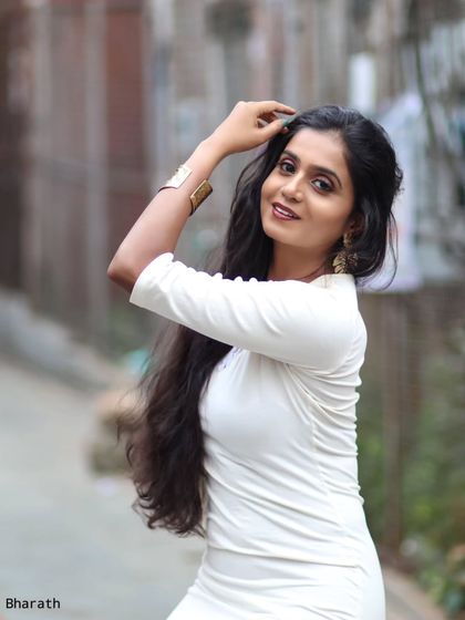 A classic three-quarter portrait on a city street. The blurred background gives a sense of the urban environment without being distracting.