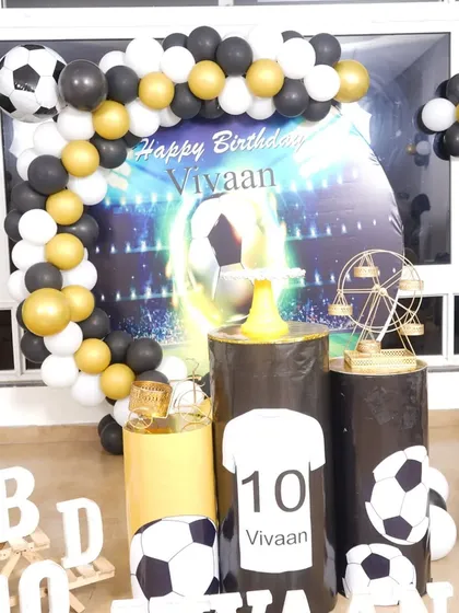 For the little football fan, this theme is a perfect score. I use a backdrop with a stadium graphic, custom printed pedestals, and a black, white, and gold balloon arch to create a sporty vibe.