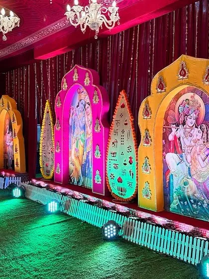 This side view shows the layered effect of our decorative panels for the Bhagwat Sapta event. Each panel features a different deity, illuminated to create depth and visual interest along the main walkway.