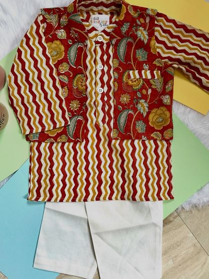 A perfect blend of tradition and style. This kurta set features a mix of floral and zigzag patterns in earthy red and mustard tones, crafted from the softest cotton.