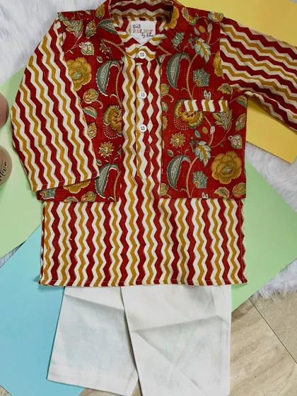 A perfect blend of tradition and style. This kurta set features a mix of floral and zigzag patterns in earthy red and mustard tones, crafted from the softest cotton.