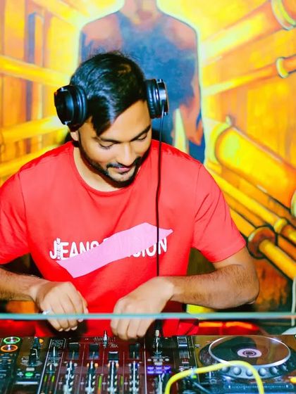 A smile of satisfaction while working the mixer. This is the look of a DJ who knows the next track is going to be a banger.