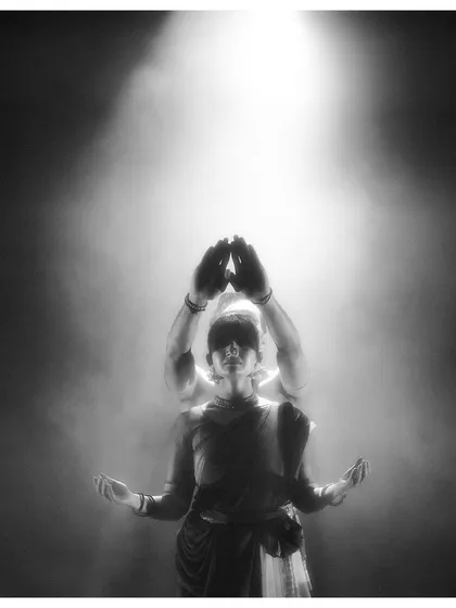 An artistic, slow-shutter photograph from 'Nagamandala'. This captures the movement and ethereal quality of the performance, showing the dance as a fluid, spiritual experience.