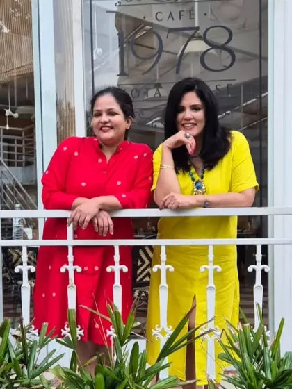Posing with my friend outside a cafe, our contrasting red and yellow dresses look so vibrant together.