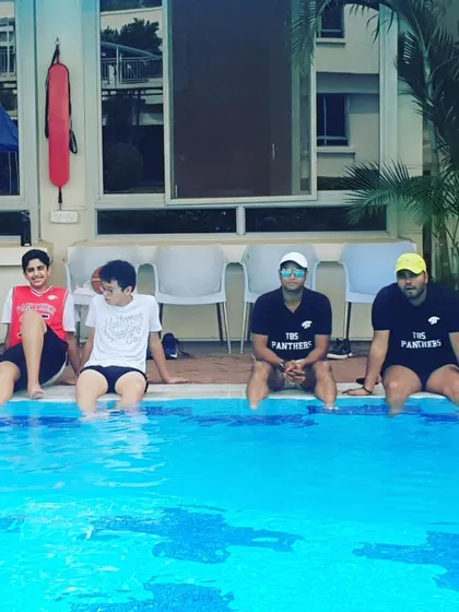 A moment of relaxation for the team and coaches by the pool after a tough tournament. Building team camaraderie off the court is just as important as the drills we run on it.