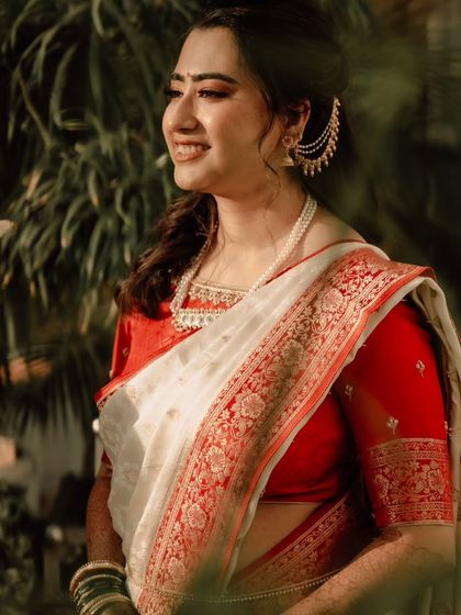 A sun-kissed shot of the bride during her Varmala ceremony. The natural light makes her skin glow beautifully.