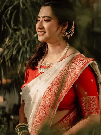 A sun-kissed shot of the bride during her Varmala ceremony. The natural light makes her skin glow beautifully.