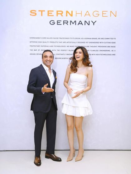 A candid, happy moment between the brand head and Diana Penty in front of the official media wall. Capturing these interactions adds a human element to corporate event coverage.