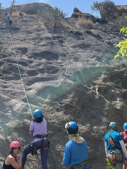 Beginners watch and learn as a fellow participant scales the rock at our 39th workshop. The group dynamic is a huge part of the learning process, with everyone cheering each other on.