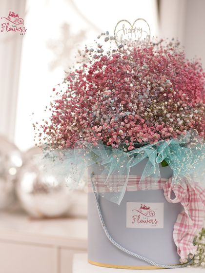 A dreamy cloud of pink and blue gypsophila, also known as baby's breath, presented in a soft blue bucket box. This delicate and airy arrangement is a popular choice for birthdays and baby showers.