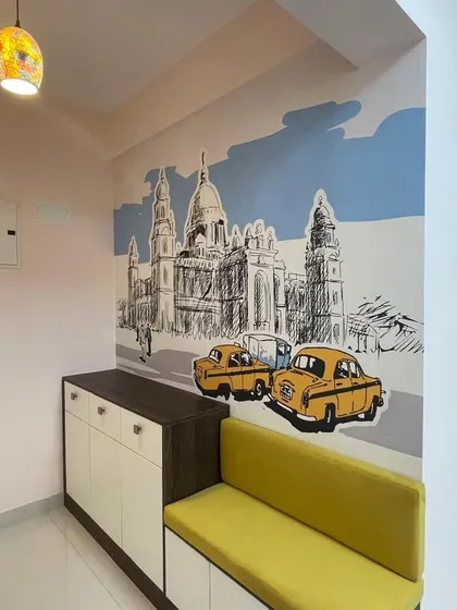A charming sketch-style mural of a city scene, possibly Bengaluru or Kolkata, with classic cars. This design adds a touch of nostalgia and urban character to this entryway.