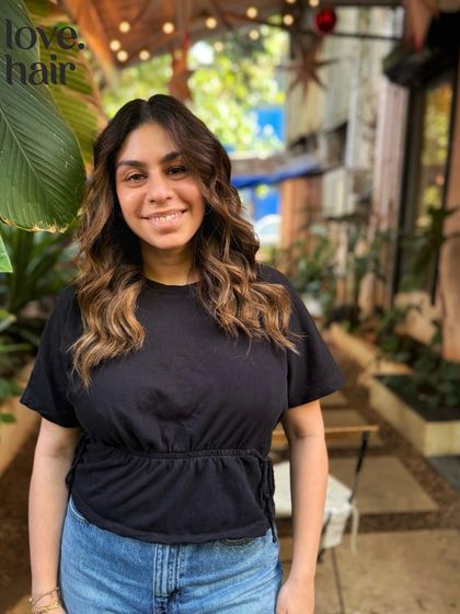 The happy client reveal of her 'sun-kissed' balayage. The warm, golden tones perfectly complement her smile.