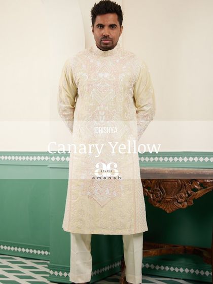 A stylized full-length shot of the canary yellow embroidered kurta.