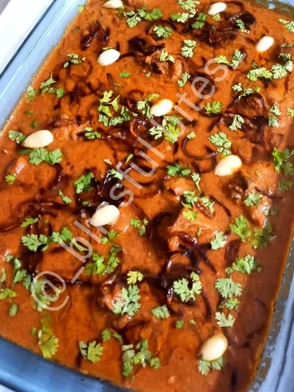 My Badam Chicken, a luxurious curry made with a paste of almonds (badam), giving it a unique nutty flavour and rich consistency. It's garnished with fried onions and cilantro.