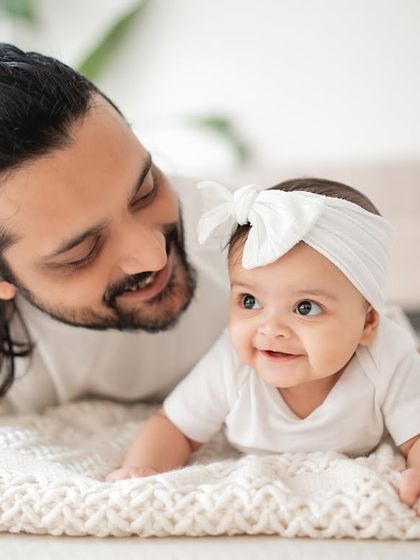 A sweet moment between a father and his baby girl during a lifestyle session at home.