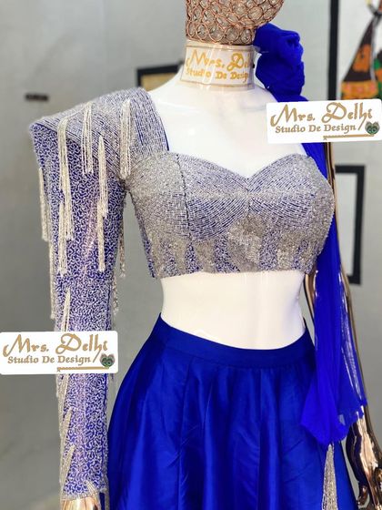 The full blouse of our hand-worked shoulder cowl lehenga choli. The combination of the sweetheart neckline and the single, heavily embellished sleeve creates a unique and modern bridal look.