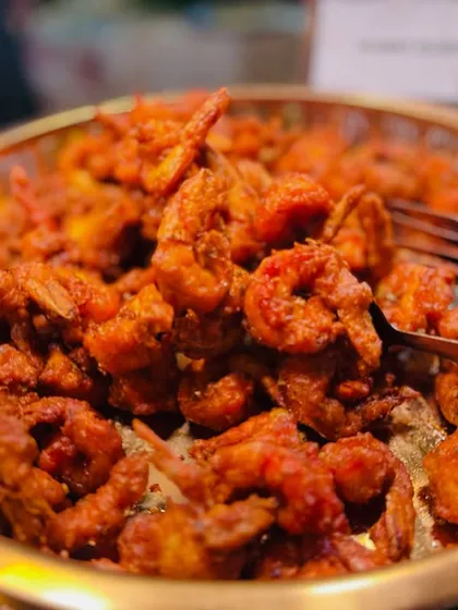 A close-up of the Prawns Koliwada, showing the crispy texture and rich color of this popular seafood starter.