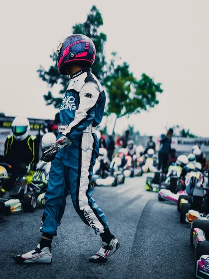 A driver walks along the grid, focused and ready.