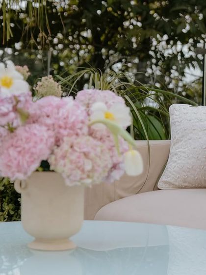 A detail of the floral arrangements and custom cushions at the Lagan Lakhwanu ceremony. The soft pastel palette created a serene and romantic atmosphere.