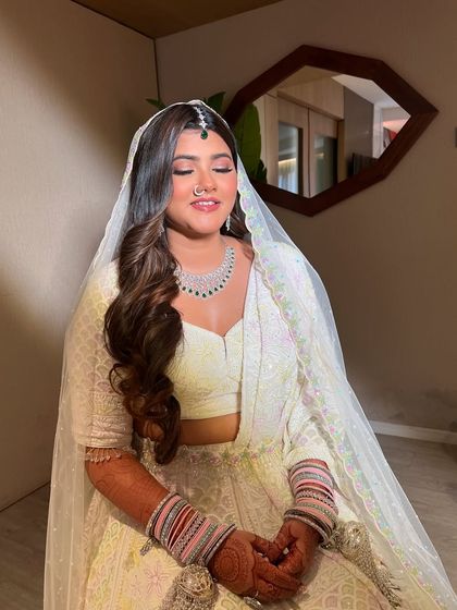 A close up with her eyes closed, highlighting the soft, neutral eyeshadow and the beautiful diamond jewelry.