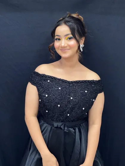 The full look, pairing the creative eye makeup with a simple black dress to make the colors pop.