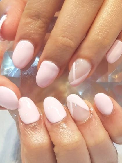 Soft and delicate, just like these baby pink nails. This simple manicure is elevated with a single accent nail featuring a subtle, geometric line design.