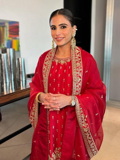The prettiest Minal for her pre-wedding Path. Her classic red suit was paired with a clean, glowing makeup look and a sleek bun.