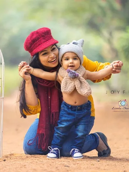 The pure joy between a mother and her child. This candid shot captures a warm, happy embrace during a chilly day, showing that beautiful family portraits can be created in any season.