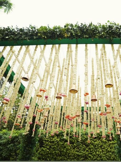 A close-up of the hanging floral decor inside the green mandap. We use a mix of tuberoses and other flowers to create these beautiful strings that add texture and fragrance to the space.
