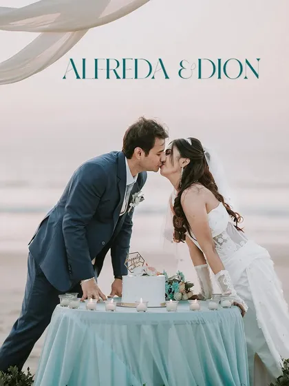 Alfreda and Dion share a kiss over their wedding cake on a Goan beach. This shot captures the beautiful culmination of a seaside ceremony, with the setting sun providing a perfect backdrop.