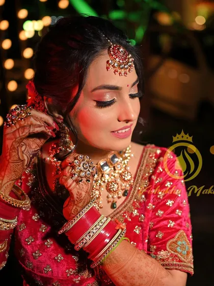 This candid shot captures the beauty of our traditional jewellery in action. The bride is seen adjusting her earring, giving a clear view of the intricate work on her oversized kundan necklace and matching pieces.