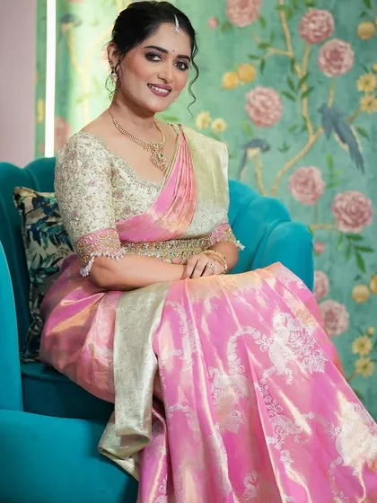 For this muhurtam look, I created a stunning Langa Voni, or half saree, in a vibrant pink brocade. The heavily embroidered cream blouse adds a touch of regal elegance, perfect for a bride's special day.