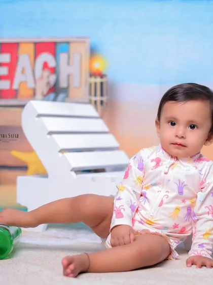 A relaxed pose on the sandy studio floor. This photo captures a calm and sweet moment during the fun-filled beach-themed session.