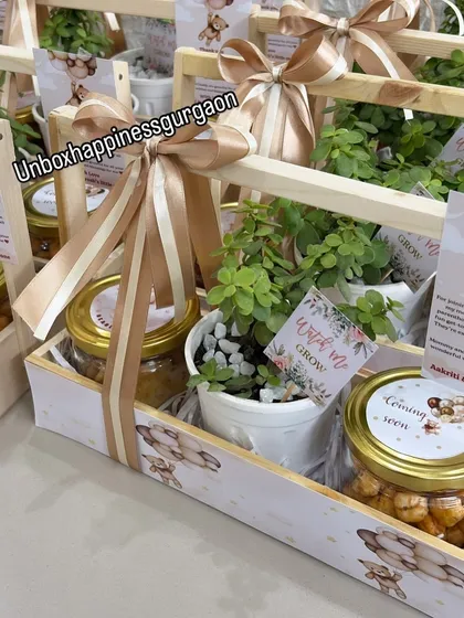 A side view of the teddy bear themed baby shower favors, showing the elegant striped ribbon and the "Watch me Grow" tag on the plant.