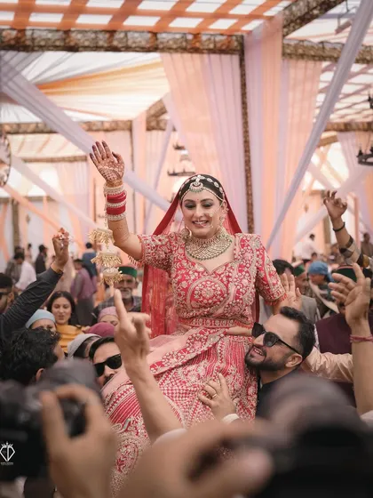 The energy of a wedding is in its people. Capturing the bride lifted up by her cheering family and friends is what it's all about. These are the high-energy, unscripted moments of celebration that truly define the spirit of an Indian wedding.
