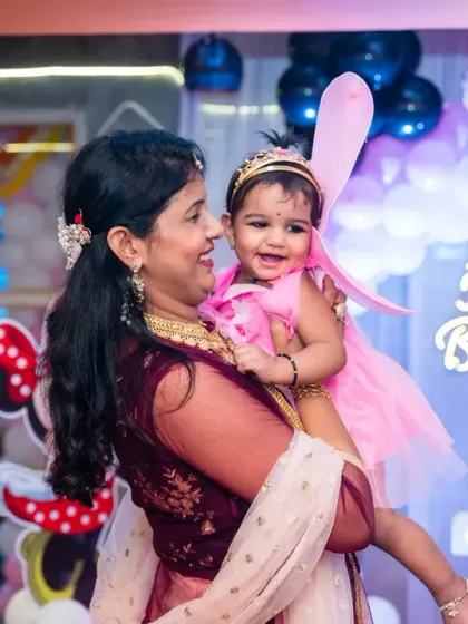 A mother's joy is so pure, especially on her baby's first birthday. This candid moment, with the little one dressed as a fairy, is exactly the kind of precious memory I aim to freeze in time during birthday celebrations.