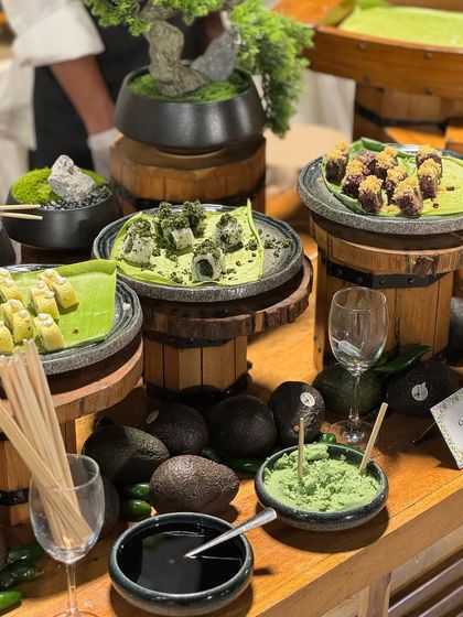 Our green-themed sushi and appetizer station. We use fresh, natural ingredients like avocado and edible greens to create a visually cohesive and healthy spread.