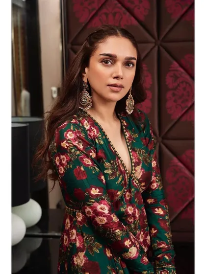 This dark green floral sharara set by Prints by Radhika is a stunning fusion piece. The peplum-style top and matching pants are perfect for a pre-wedding event or festive party.